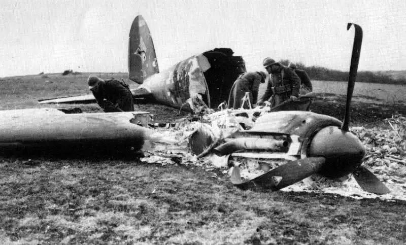 French soldiers in Adrian helmets examining wreckage of a downed German Heinkel He 111 bomber in France 1940.