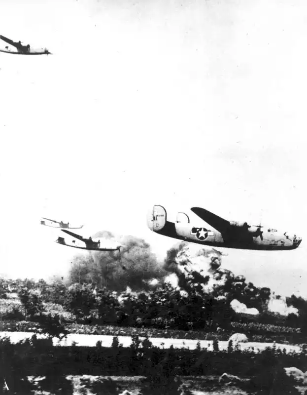 USAAF B-24 Liberator Li'l Jughaid flying at tree-top level over exploding oil refineries in Ploiești Romania 1943.