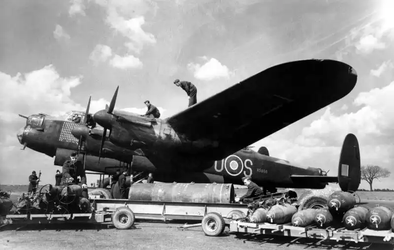 RAAF Avro Lancaster bomber R5868 S for Sugar ground crew loading 4000 lb Cookie bomb at RAF Waddington 1944.
