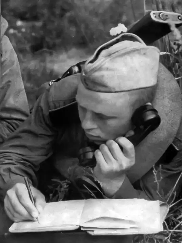 Soviet soldier from the Red Army communications receiving a telegram on the TAI-43 telephone during WWII.