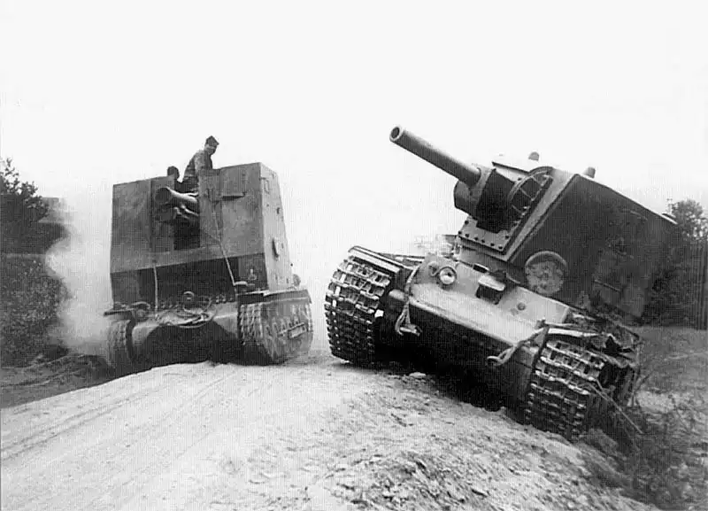 German sIG-33 drives past abandoned KV-2 with rare MT-1 turret. Eastern Front, 1941.