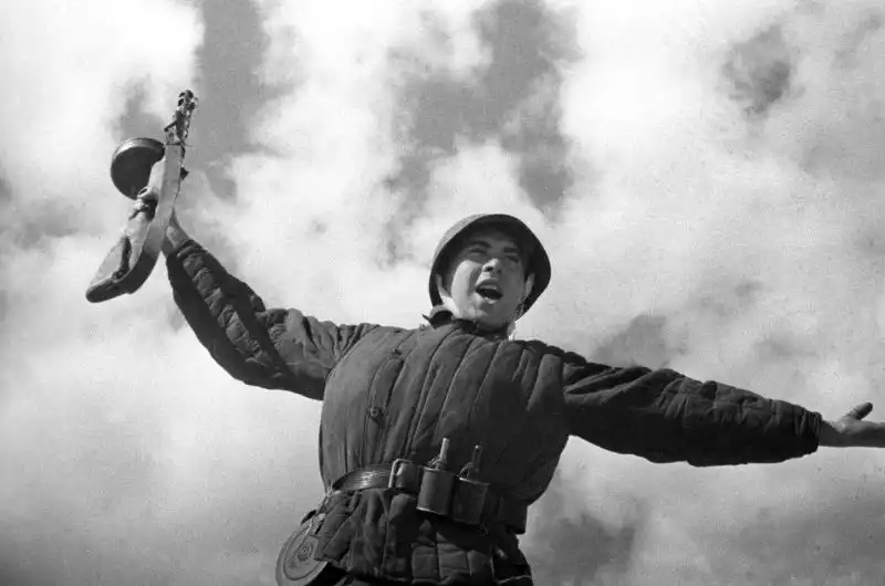 Heroic Soviet soldier armed with a PPSh-41 submachine gun and RG-42 grenades, leading the charge during the liberation of Belarus, 1944.