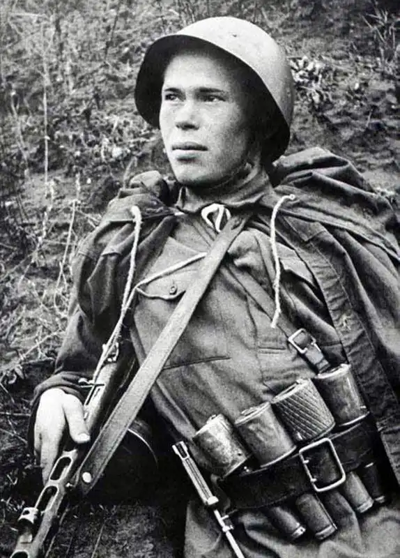 Soviet Red Army recon scout Nikolai Romanov holding PPSh-41 submachine gun with RGD-33 stick grenades in Stalingrad August 1942.