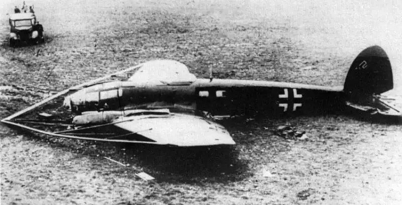 Downed Heinkel He 111 H-8 bomber with massive nose-mounted balloon cable cutter frame in an English field.