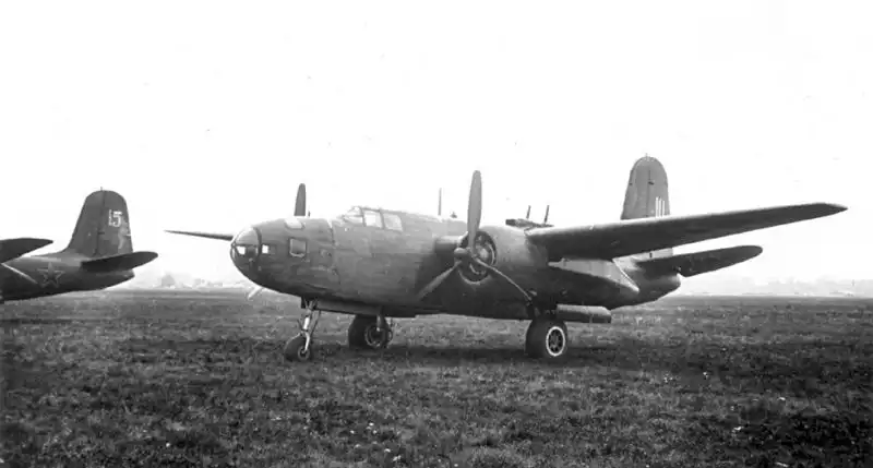 Soviet Naval Aviation Douglas A-20G Boston torpedo bomber with a glazed nose and suspended aerial torpedo resting on an airfield in Germany, 1945.