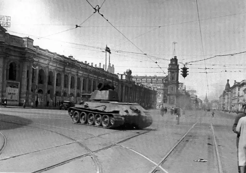 Soviet T-34 tank driving along Nevsky Prospect near Sadovaya Street in besieged Leningrad during the Siege of Leningrad, spring 1943