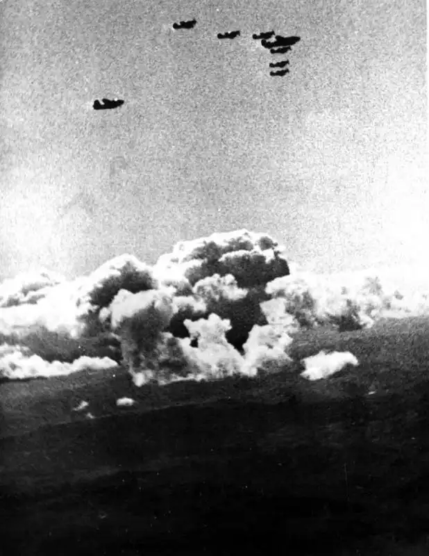 Formation of American Lend-Lease planes B-25 Mitchell and P-63 Kingcobra flying over snow-covered mountains in Yakutia 1944.