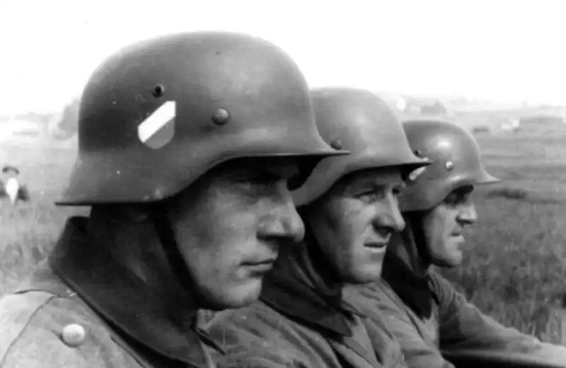Three German soldiers riding an Austro-Daimler ADMK/WARK half-track artillery tractor in Poland during the 1939 campaign.