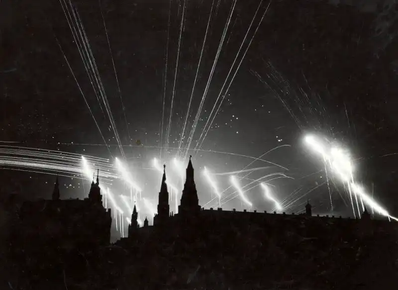 Luftwaffe night raid on Moscow, July 26, 1941, with Soviet anti-aircraft guns firing at bombers dropping parachute flares.
