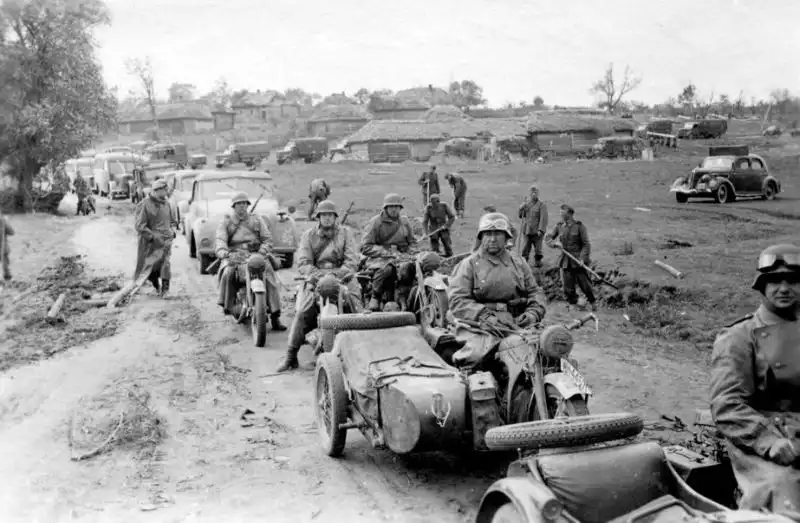 A mechanized column of German troops from the 298th Infantry Division on the march through Ukraine during the Battle for Ukraine, July 1941, featuring Tatra V809, Horch 901, and Zündapp motorcycles.