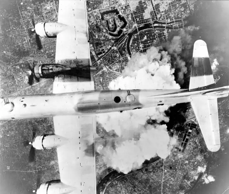 B-29 Superfortress “Incendiary Journey” bombing Osaka with one engine disabled during the American firebombing campaign, March 1945.