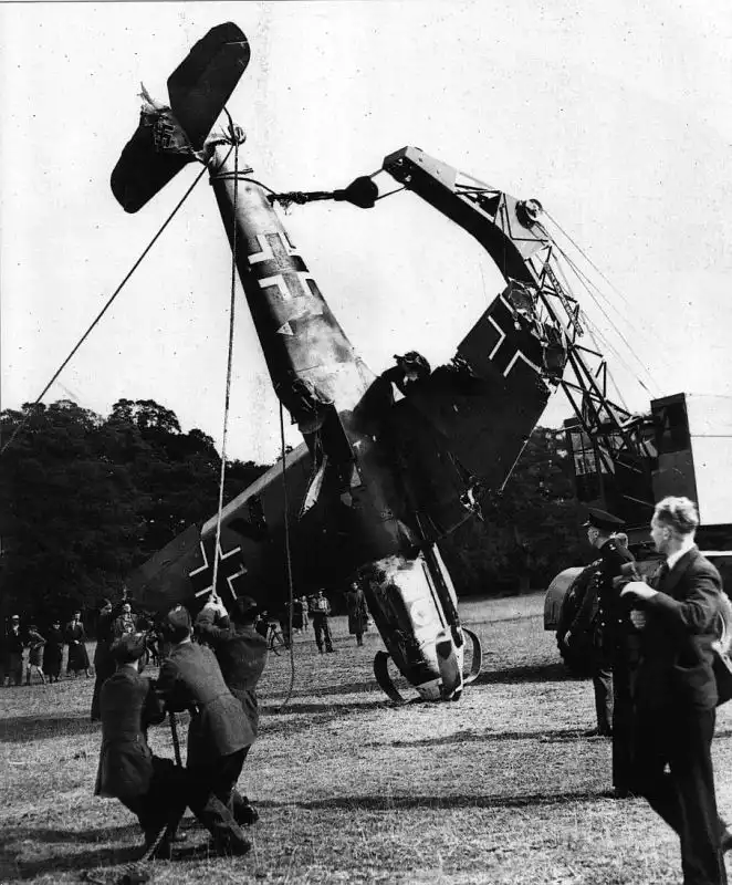 British recovery crews loading a damaged German Messerschmitt Bf 109 fighter aircraft after a forced landing during the Battle of Britain in 1940