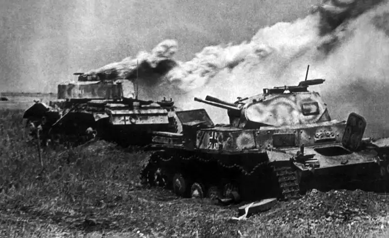 Burning German Panzer III and disabled Panzer II tanks destroyed during the Battle of Kursk in the summer of 1943.