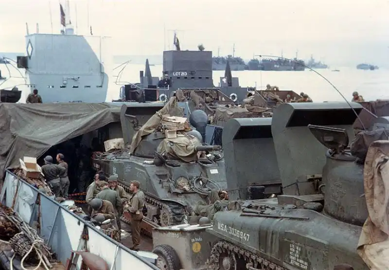 U.S. M4 Sherman tanks equipped with snorkels aboard landing ships, preparing for D-Day invasion