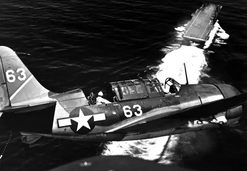 Two SB2C Helldiver bombers landing on USS Yorktown aircraft carrier in the Pacific, July 1944