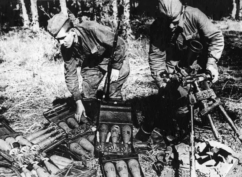 Soviet Red Army soldiers inspect a captured German 8 cm Granatwerfer 34 mortar and smoke ammunition on the Eastern Front during the summer of 1942.