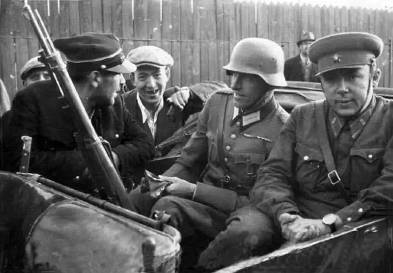 German and Soviet officers speaking with a Polish railway worker during the invasion of Poland, September 1939