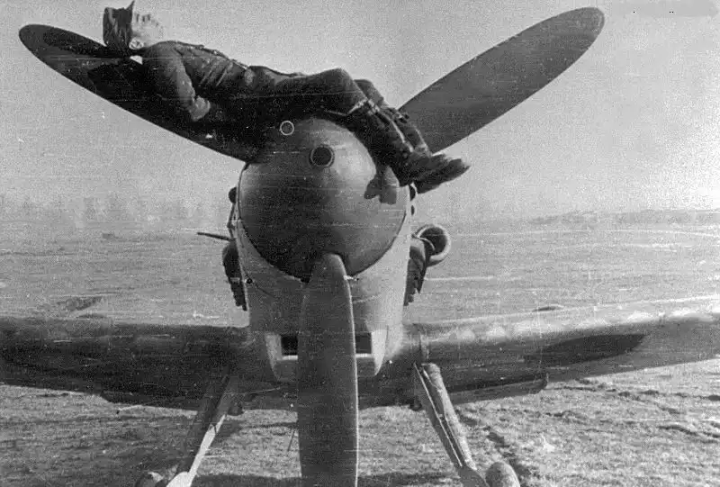 Heinz Mertens, mechanic of Luftwaffe ace Erich Hartmann, reclining on the propeller of a Messerschmitt Bf 109 fighter.