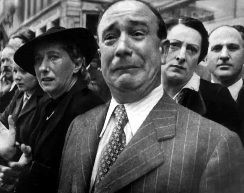 Residents of Marseille watching the evacuation of French army flags to North Africa in February 1941 after the French defeat by Nazi Germany.