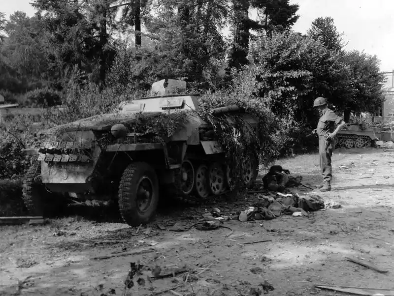 Wrecked German half-track from the 1st SS Panzer Division, destroyed by a 57mm AT gun near Le Neufbourg, August 1944.