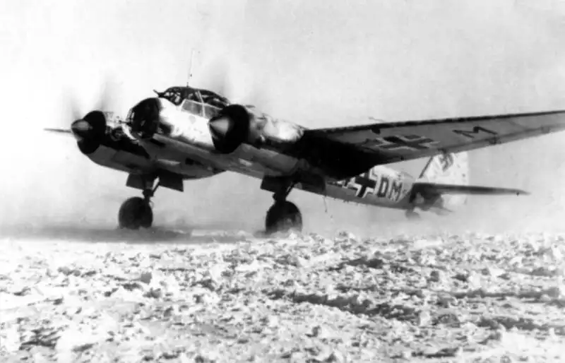 German Junkers Ju 88 medium bomber from 4./KG 1 parked on a snow-covered field airfield on the Eastern Front, USSR, 1941.