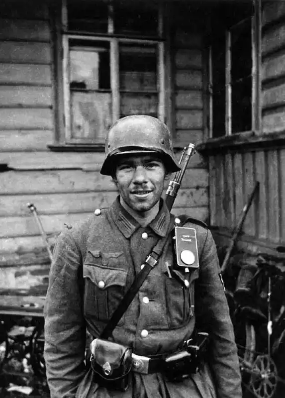 German soldier standing in a captured Soviet village during anti-partisan operations, Eastern Front, 1941.