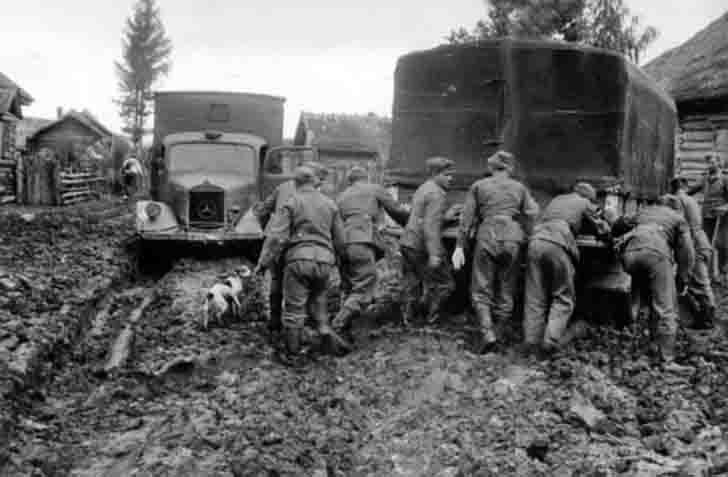 Trucks of the Wehrmacht drowned in the mud on the street in Russian village