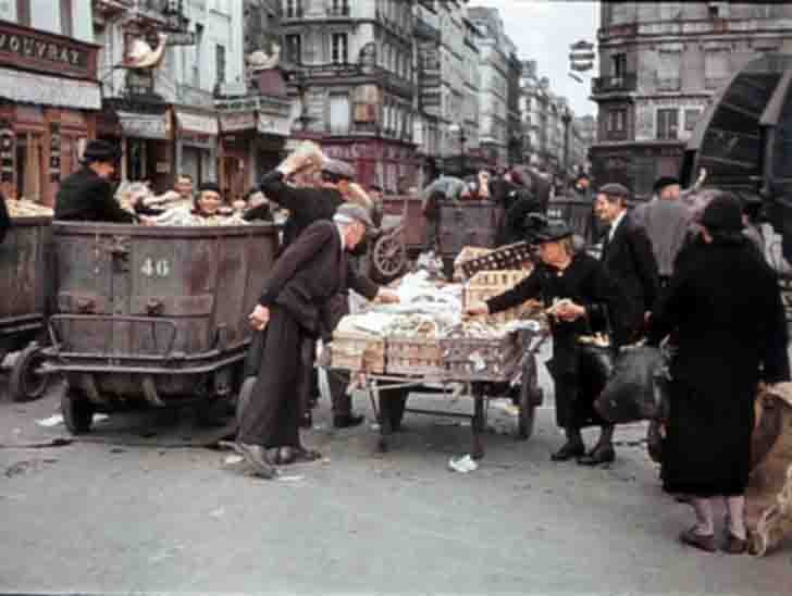 Residents of occupied Paris, looking for food in garbage cans