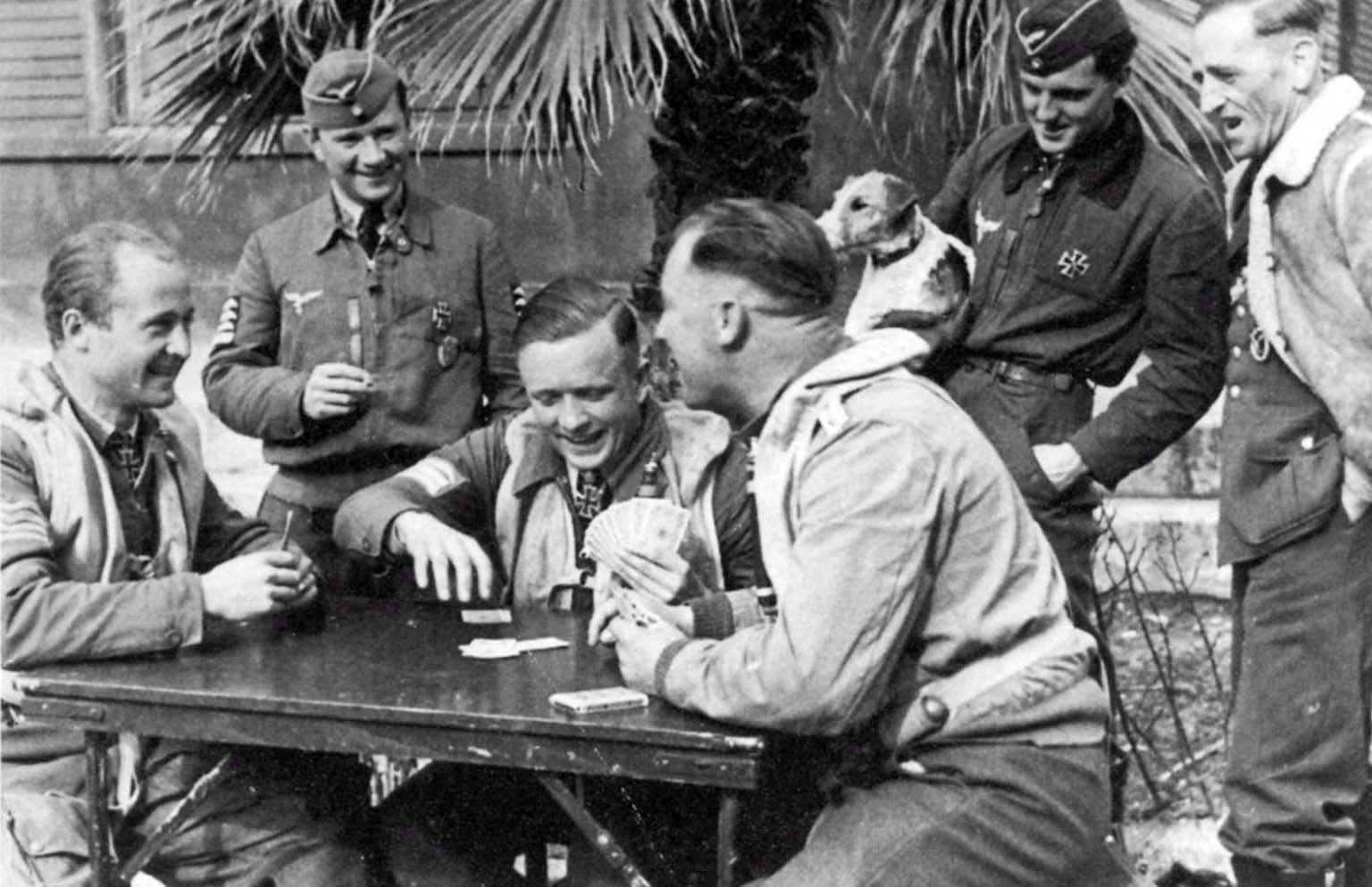 German pilots of the 53rd Luftwaffe Fighter Squadron are playing cards