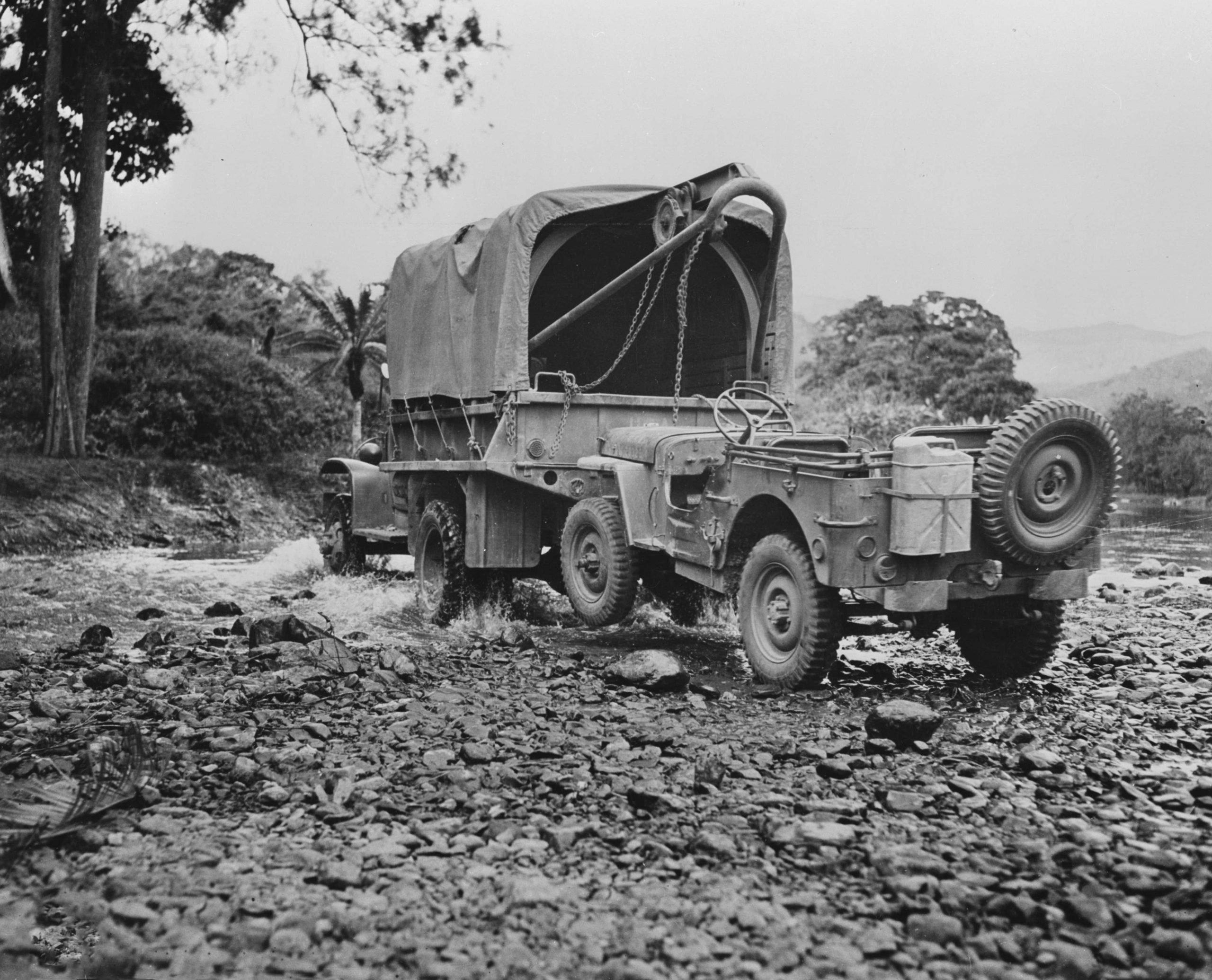 An American truck tows a Willis jeep