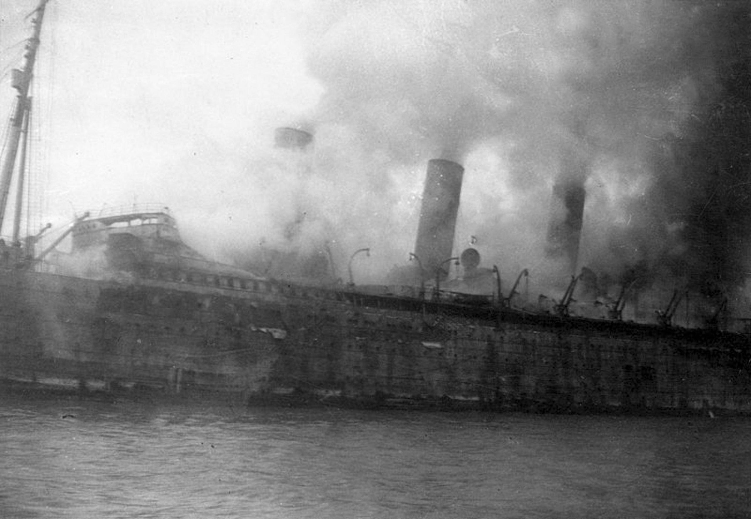 A burning British Empress of Asia passenger liner